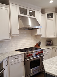 White Kitchen With Granite Countertops - Oven and Hood