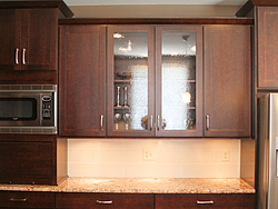 Warm Kitchen With Backsplash Details - Glass Cabinet Doors