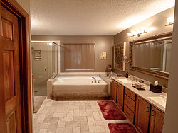 Warm Bathroom With Glass Shower - Tile Floor