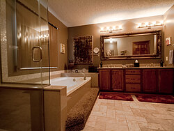 Warm Bathroom With Glass Shower - Dual Sinks